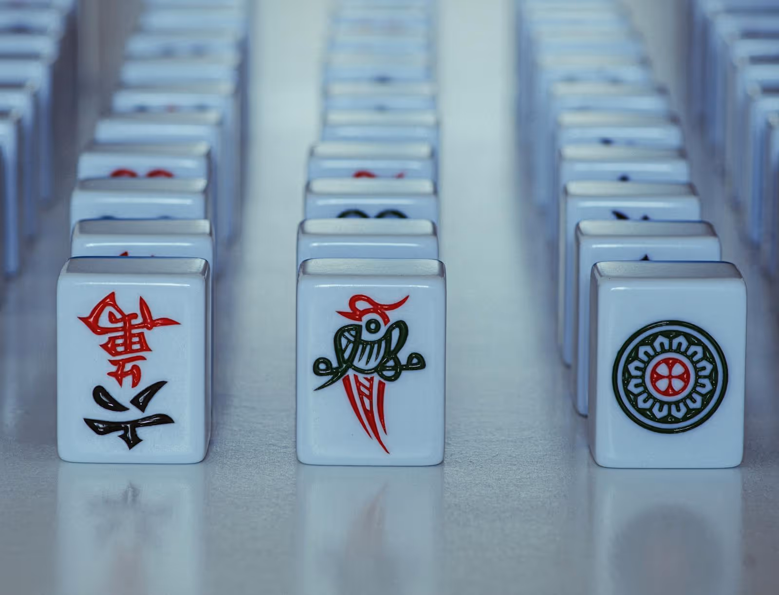 Mahjong tiles standing in a row, one face turned to the light